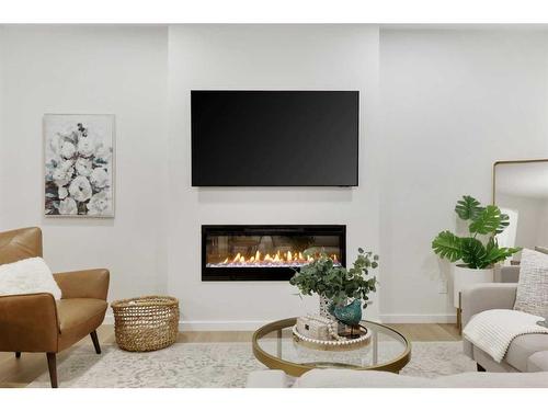 907 Langholm Drive Se, Airdrie, AB - Indoor Photo Showing Living Room With Fireplace