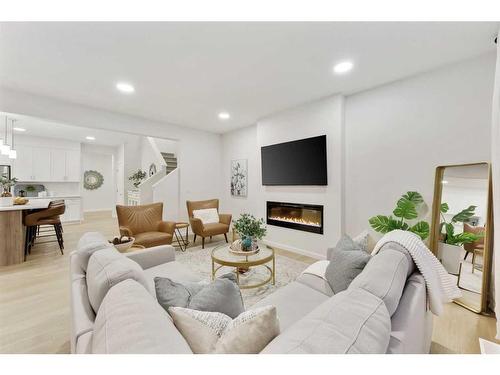 907 Langholm Drive Se, Airdrie, AB - Indoor Photo Showing Living Room With Fireplace