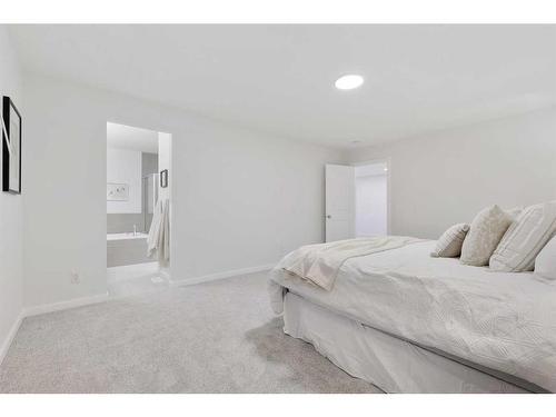 907 Langholm Drive Se, Airdrie, AB - Indoor Photo Showing Bedroom