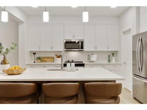 907 Langholm Drive Se, Airdrie, AB - Indoor Photo Showing Kitchen With Upgraded Kitchen