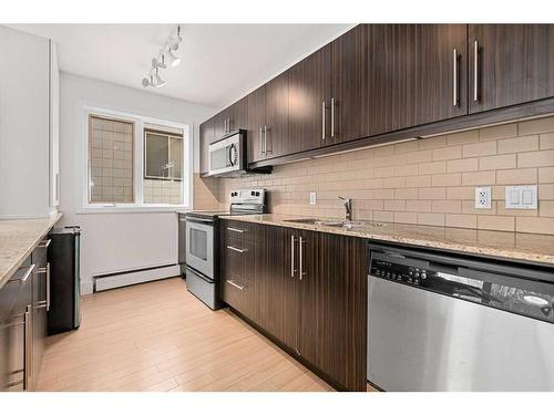 305-824 4 Avenue Nw, Calgary, AB - Indoor Photo Showing Kitchen With Stainless Steel Kitchen