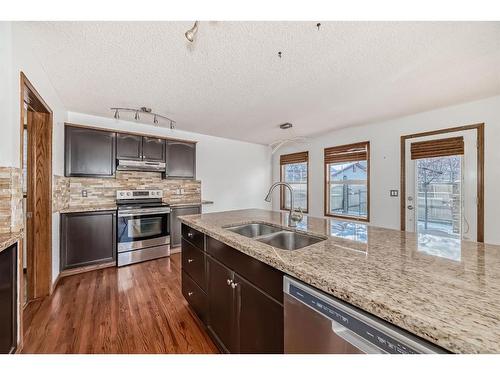 114 Bow Ridge Crescent, Cochrane, AB - Indoor Photo Showing Kitchen With Double Sink With Upgraded Kitchen