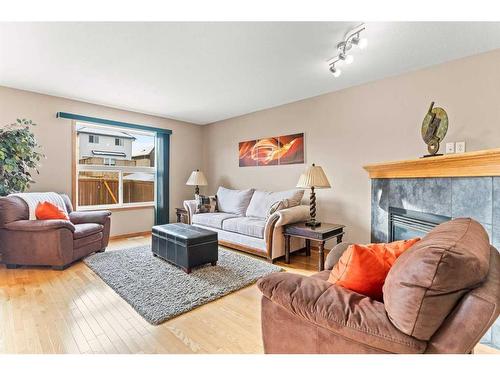 210 Saddlemont Boulevard Ne, Calgary, AB - Indoor Photo Showing Living Room With Fireplace