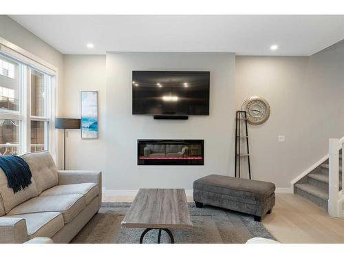 277 Ambleside Avenue Nw, Calgary, AB - Indoor Photo Showing Living Room With Fireplace