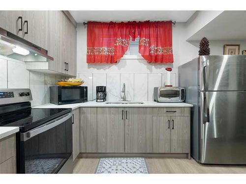 277 Ambleside Avenue Nw, Calgary, AB - Indoor Photo Showing Kitchen With Double Sink