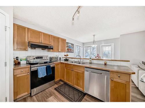 126 Hidden Creek Rise Nw, Calgary, AB - Indoor Photo Showing Kitchen With Double Sink