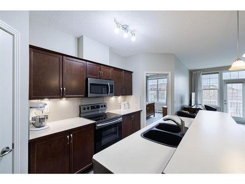 333-1 Crystal Green Lane, Okotoks, AB - Indoor Photo Showing Kitchen With Double Sink With Upgraded Kitchen