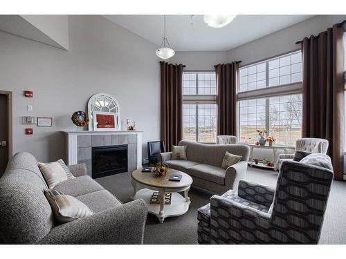 333-1 Crystal Green Lane, Okotoks, AB - Indoor Photo Showing Living Room With Fireplace