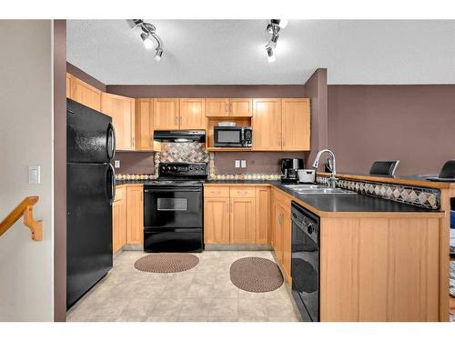 102 Cranberry Square Se, Calgary, AB - Indoor Photo Showing Kitchen With Double Sink