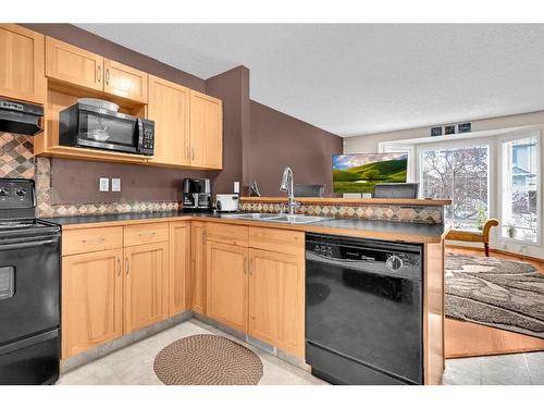 102 Cranberry Square Se, Calgary, AB - Indoor Photo Showing Kitchen With Double Sink