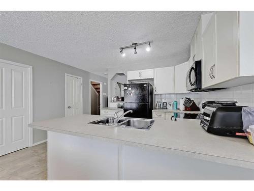 75-105 Drake Landing Common, Okotoks, AB - Indoor Photo Showing Kitchen With Double Sink