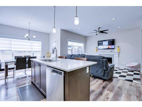 126 Saddlestone Park Ne, Calgary, AB - Indoor Photo Showing Kitchen With Fireplace With Double Sink