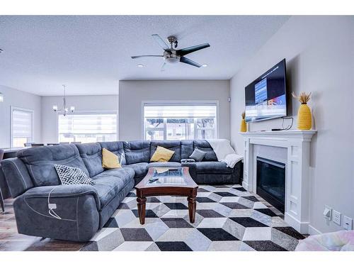 126 Saddlestone Park Ne, Calgary, AB - Indoor Photo Showing Living Room With Fireplace