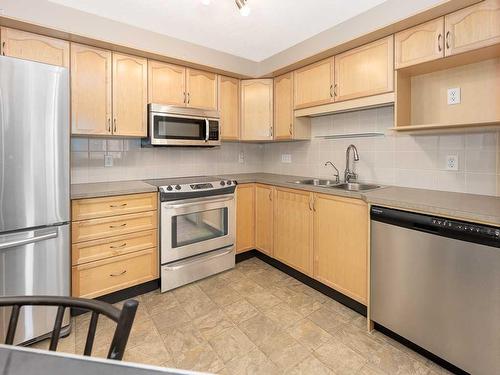 2207-200 Community, Okotoks, AB - Indoor Photo Showing Kitchen With Double Sink