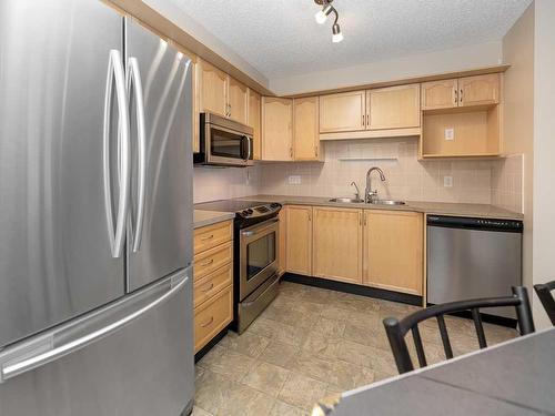 2207-200 Community, Okotoks, AB - Indoor Photo Showing Kitchen With Double Sink