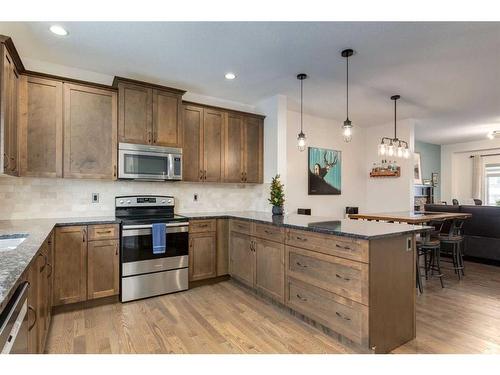 200 Heartland Way, Cochrane, AB - Indoor Photo Showing Kitchen With Stainless Steel Kitchen