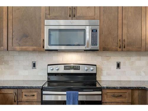 200 Heartland Way, Cochrane, AB - Indoor Photo Showing Kitchen With Stainless Steel Kitchen