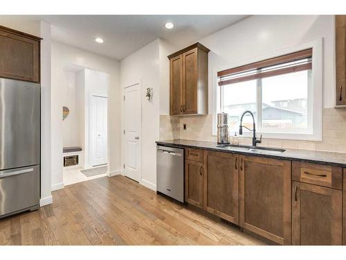 200 Heartland Way, Cochrane, AB - Indoor Photo Showing Kitchen With Stainless Steel Kitchen With Double Sink