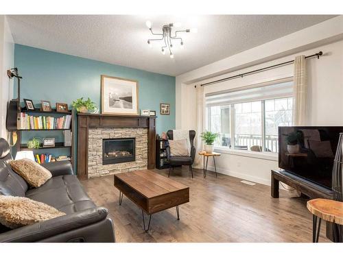 200 Heartland Way, Cochrane, AB - Indoor Photo Showing Living Room With Fireplace