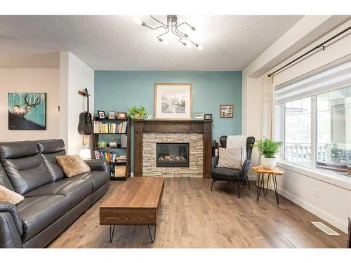 200 Heartland Way, Cochrane, AB - Indoor Photo Showing Living Room With Fireplace