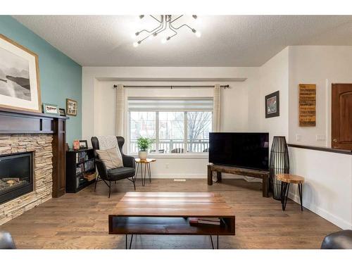 200 Heartland Way, Cochrane, AB - Indoor Photo Showing Living Room With Fireplace