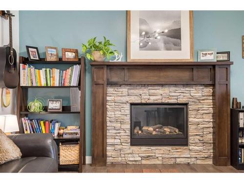 200 Heartland Way, Cochrane, AB - Indoor Photo Showing Living Room With Fireplace