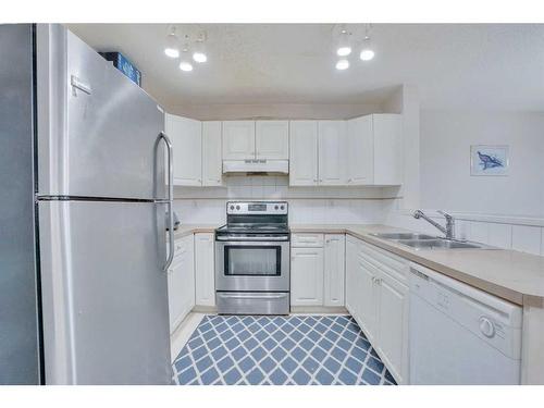 81 Taravista Way Ne, Calgary, AB - Indoor Photo Showing Kitchen With Double Sink