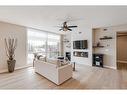 409-15 Cougar Ridge Landing Sw, Calgary, AB  - Indoor Photo Showing Living Room With Fireplace 