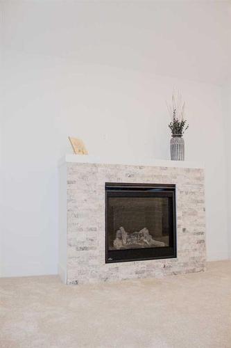 1441 Scarlett Ranch Boulevard, Carstairs, AB - Indoor Photo Showing Living Room With Fireplace