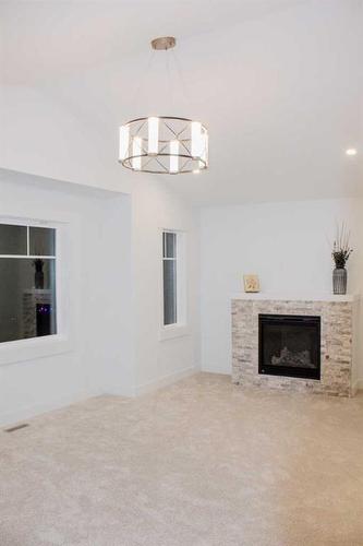 1441 Scarlett Ranch Boulevard, Carstairs, AB - Indoor Photo Showing Living Room With Fireplace