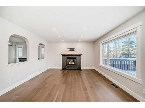 248 Tuscany Ravine View Nw, Calgary, AB - Indoor Photo Showing Living Room With Fireplace