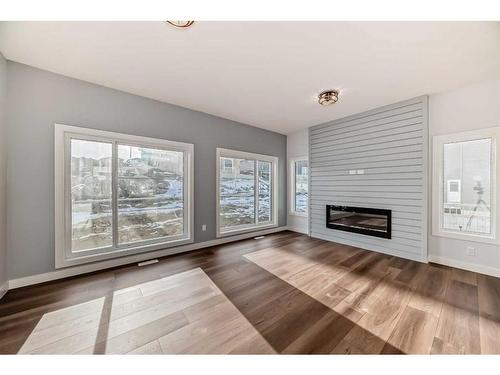 488 Rivercrest View, Cochrane, AB - Indoor Photo Showing Other Room With Fireplace