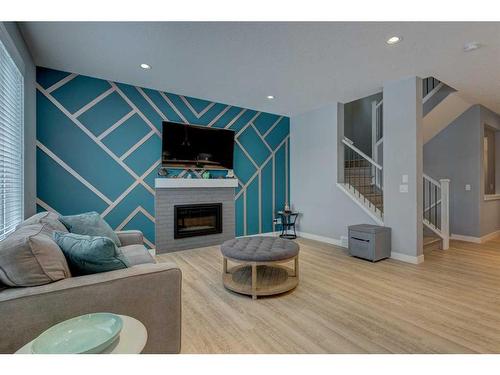 28 Crestbrook Way Sw, Calgary, AB - Indoor Photo Showing Living Room With Fireplace