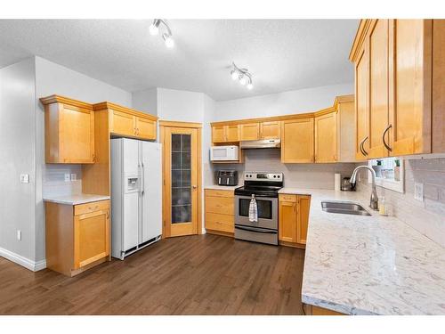 929 Channelside Road Sw, Airdrie, AB - Indoor Photo Showing Kitchen With Double Sink