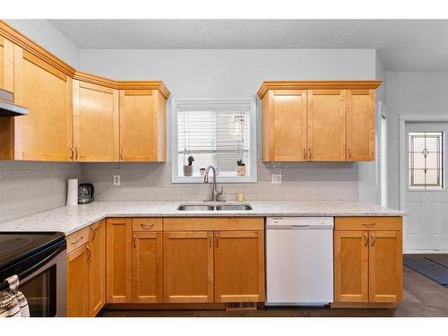 929 Channelside Road Sw, Airdrie, AB - Indoor Photo Showing Kitchen With Double Sink