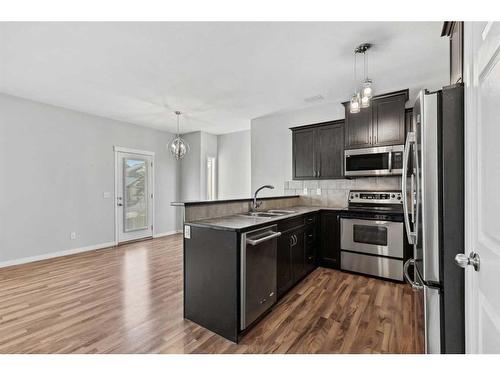 56 Arbours Circle Nw, Langdon, AB - Indoor Photo Showing Kitchen With Stainless Steel Kitchen With Double Sink With Upgraded Kitchen