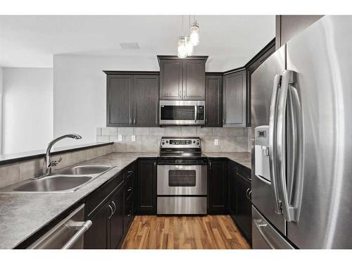 56 Arbours Circle Nw, Langdon, AB - Indoor Photo Showing Kitchen With Stainless Steel Kitchen With Double Sink