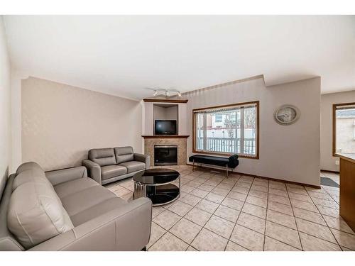 26 Arbour Butte Road Nw, Calgary, AB - Indoor Photo Showing Living Room With Fireplace