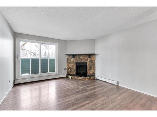 3208-80 Glamis Drive Sw, Calgary, AB - Indoor Photo Showing Living Room With Fireplace