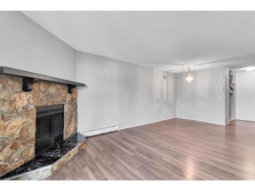 3208-80 Glamis Drive Sw, Calgary, AB - Indoor Photo Showing Living Room With Fireplace