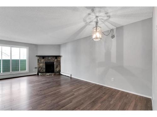 3208-80 Glamis Drive Sw, Calgary, AB - Indoor Photo Showing Living Room With Fireplace