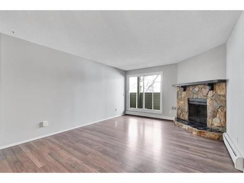 3208-80 Glamis Drive Sw, Calgary, AB - Indoor Photo Showing Living Room With Fireplace