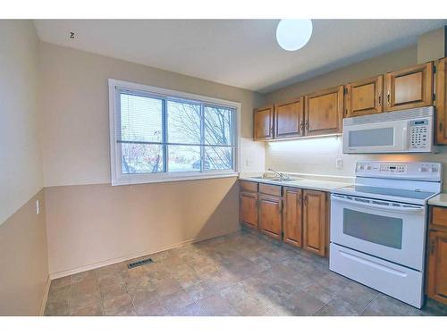 1290 Ranchlands Road Nw, Calgary, AB - Indoor Photo Showing Kitchen With Double Sink