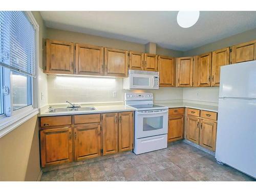 1290 Ranchlands Road Nw, Calgary, AB - Indoor Photo Showing Kitchen With Double Sink