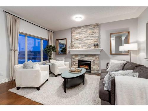 38-39 Strathlea Common Sw, Calgary, AB - Indoor Photo Showing Living Room With Fireplace