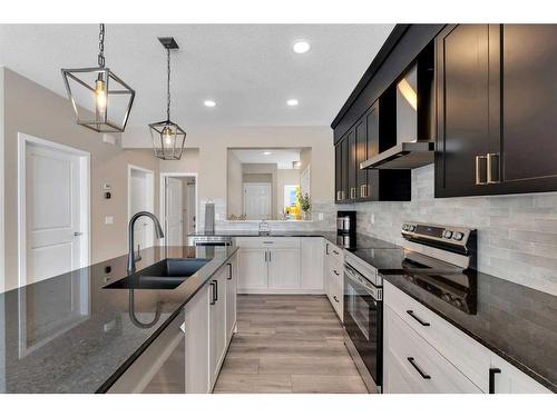 26 Cobbleridge Place Sw, Airdrie, AB - Indoor Photo Showing Kitchen With Double Sink With Upgraded Kitchen