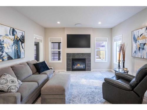 9 Silverado Saddle Heights Sw, Calgary, AB - Indoor Photo Showing Living Room With Fireplace