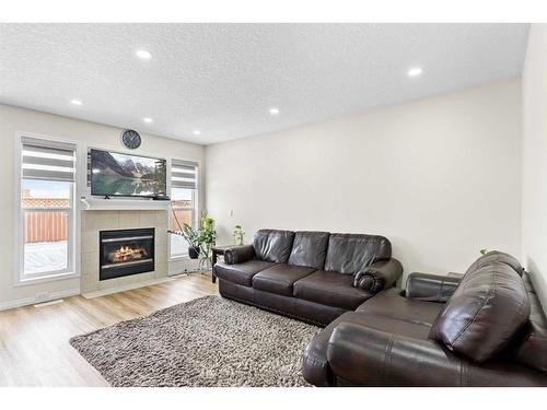 343 Taracove Estate Drive Ne, Calgary, AB - Indoor Photo Showing Living Room With Fireplace