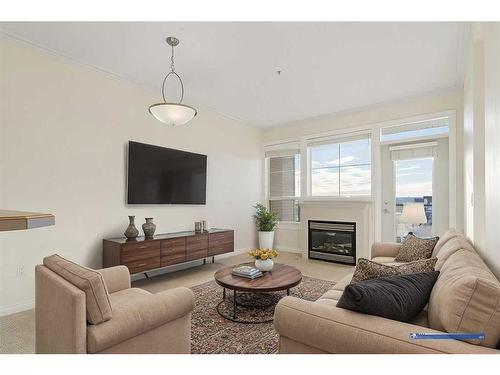 3234-1010 Arbour Lake Road Nw, Calgary, AB - Indoor Photo Showing Living Room With Fireplace