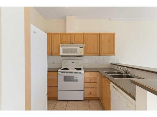 3234-1010 Arbour Lake Road Nw, Calgary, AB - Indoor Photo Showing Kitchen With Double Sink